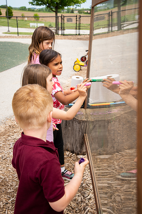 Children playing with a marker board